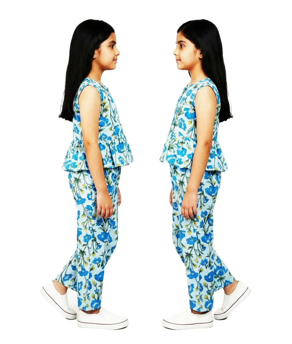 Girl in blue floral co-ord set, sleeveless top and matching pants, summer kids fashion