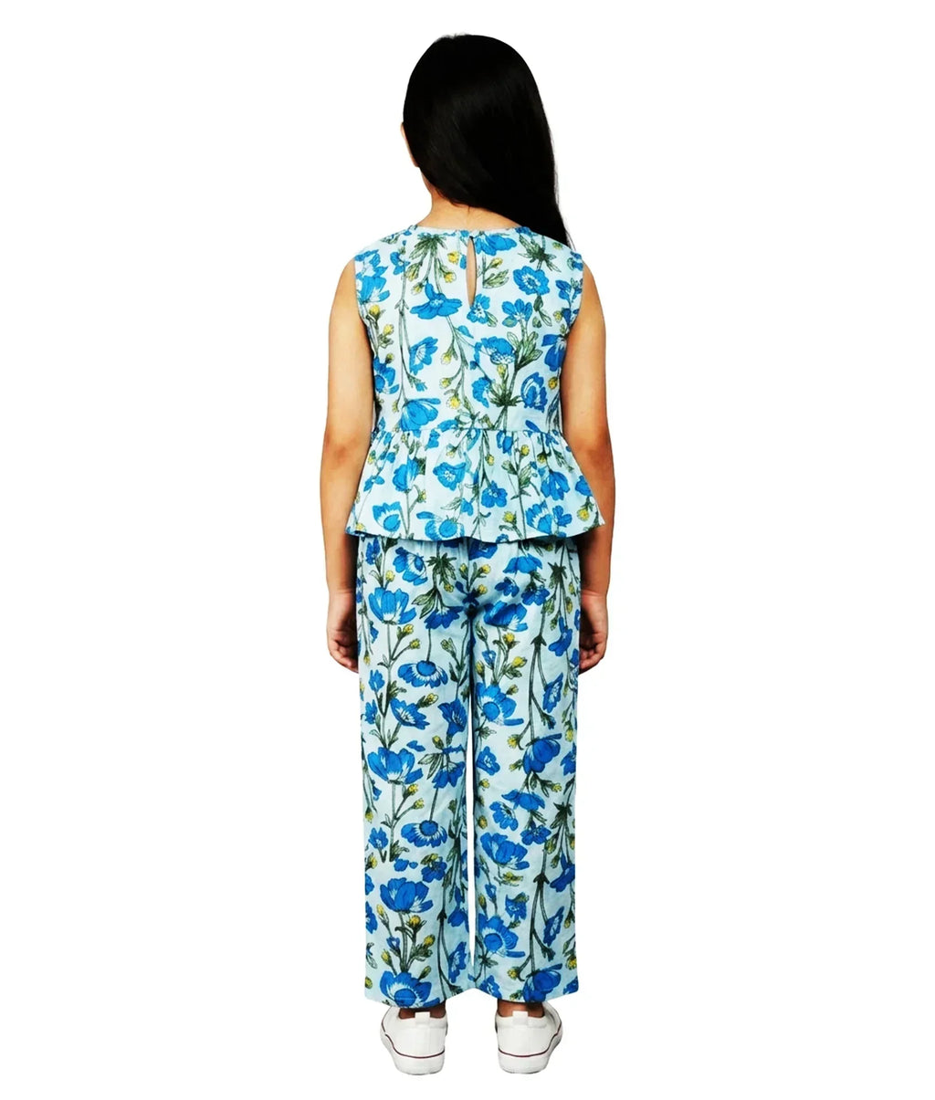 Girl in blue floral co-ord set with sleeveless top and wide-leg pants, back view