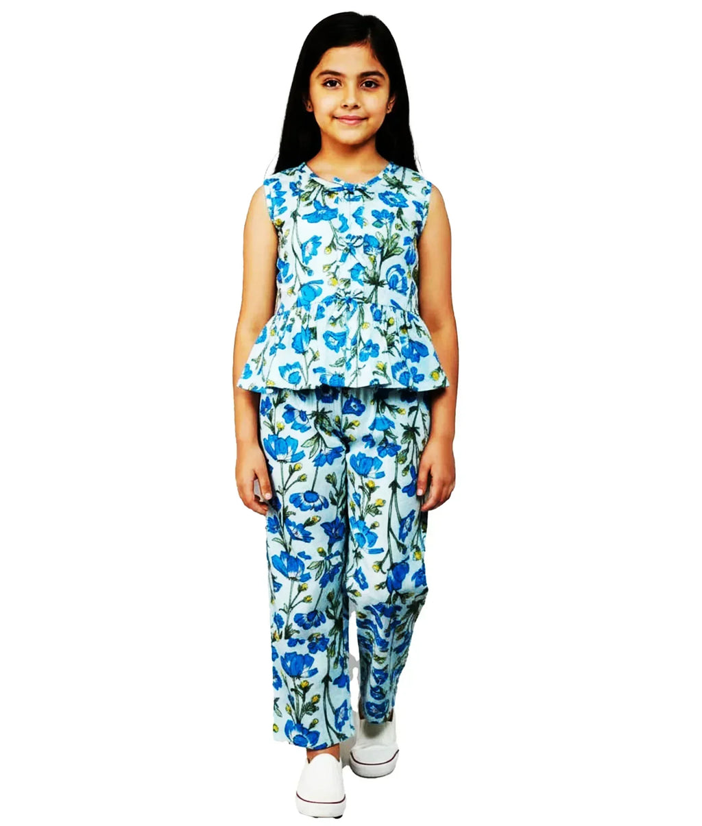 Girl in blue floral print sleeveless co-ord set and white shoes, summer kids fashion