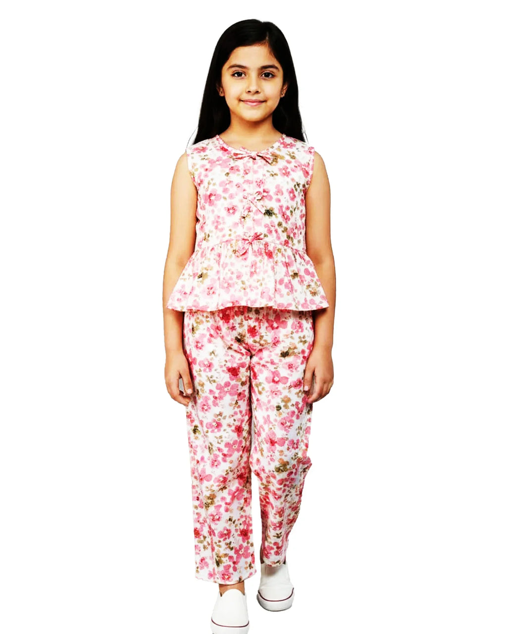 Girl in pink floral summer co-ord set with sleeveless top and pants, white background