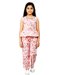 Girl in pink floral summer co-ord set with sleeveless top and pants, white background